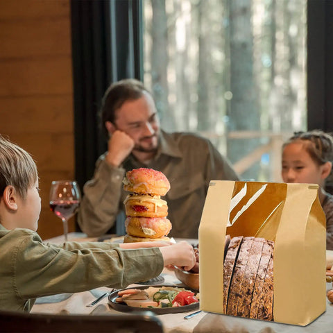 Family dinner with 100 Pack Large Paper Bread Bags With Tin Tie Tab Lock Clear Front Window showcasing sourdough bread