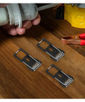 Close-up of Tough As Nails Spring Clips For Ceiling Light Fixtures And Lamp Mounting Hardware on wooden surface