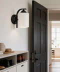 Top Tier Modern Farmhouse Wall Sconces With Solid Matte Black Frame And Soft Diffused Glass Shade Hardwired Vanity Light Fixture on entryway wall.