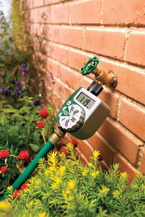 Automatic Garden Box Irrigation System Kit With 64 Sq Ft Coverage Digital Hose Timer attached to exterior faucet