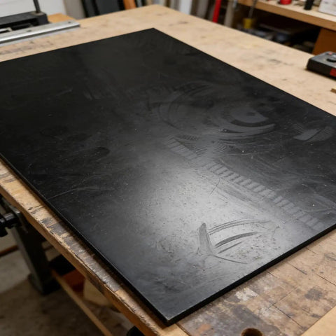 Oil And Fuel Resistant Nitrile Rubber Sheet Buna N Shore A65 For Gaskets And Sealing, black 12x8x1/8 inch NBR pad on workshop table