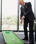 Man using Six Pack Golf Putting Cups With Flags, Plastic Mini Golf Hole Practice Aids For Adults indoors