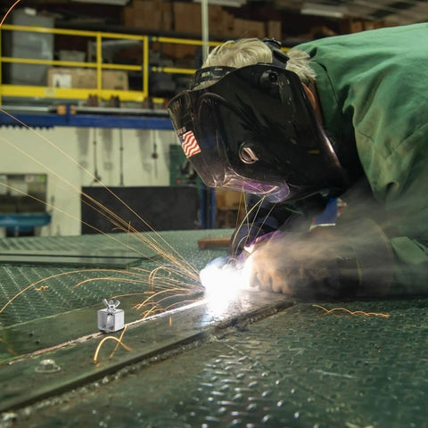 Welder using 24 Pack Butt Welding Clamps Pro Grade for Edge to Edge Welding, sparks flying during auto body panel repair.