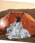 Person using Go-To 6-Piece Survival Emergency Blanket Set With Gold And Silver Reflective Foil, Portable Thermal Blankets for camping.