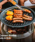 Bonfire Grill Top And Hub Cast Iron Cooktop With Stainless Steel Hub grilling sausages and peppers over fire pit