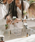 Scientists using a Two Piece Acrylic Test Tube Holder Rack With 12 Socket Vial Stand, Clear Lab Organizer Fits 15 To 18 mm Tubes.