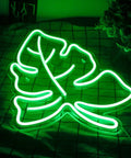 Lit Green Leaf Neon LED Night Light Sign For Home Wall Decor Neon Sign For Wedding Birthday Party Camping Kids Room Bedroom Bar Living Room Green Light lit on table