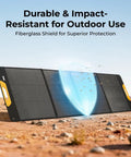 200W Portable Solar Panel With N Type Cells Foldable Fiberglass Reinforced Construction Twenty Five Percent Higher Conversion Efficiency IP65 Water Resistant For Camping RV Van Boat And Off Grid Power displayed on rocky terrain, showcasing durability with a fiberglass shield icon.