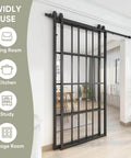 Bypass Double Glass Barn Door Kit With 84 By 84 In Clear Tempered Glass and 7.5 Ft Side Mounted Aluminum Black Frame installed in room.