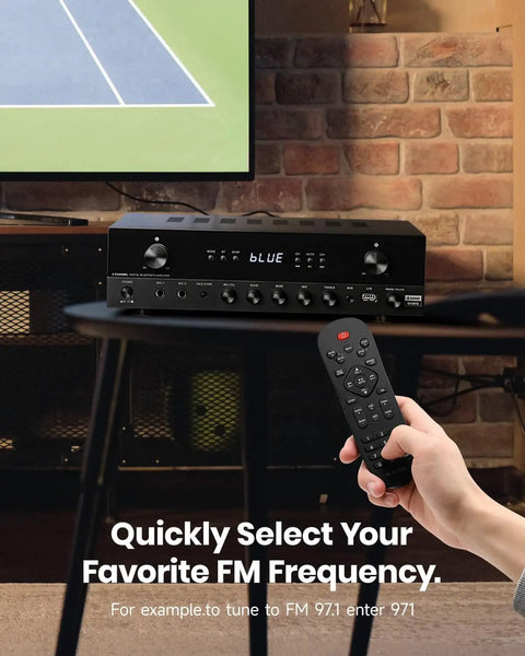 Person using remote with 600W Peak Two Channel Stereo Receiver With Bluetooth 5 3 Phono Optical Coaxial USB FM Mic In Aux RCA Input Karaoke Ready Home Theater Audio System With Remote near TV
