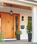 Dope 14 Inch Outdoor Pendant Light For Front Porch Featuring Adjustable Six Foot Chain And Sleek Vintage Metal Shade For Patio Entryway Hanging Lamp above wooden door.