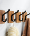 Rustic Wood Adhesive Wall Hooks Four Pack Heavy Duty Sticker Hangers Fits Coats Towels And Bags mounted on wall with towels.