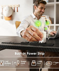 Person using built-in power strip on 55 Inch L Shaped Electric Standing Desk With Keyboard Tray And Reversible Height Adjustment