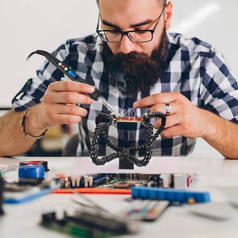 Man using Helping Hands Soldering Station With Flexible Y Shaped Arms And Non Slip Desk Clamp Base for PCB repair