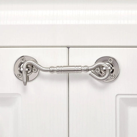 Two Pack Brushed Nickel Stainless Steel Hook And Eye Latch Four Inch Heavy Duty Barn Gate Door Lock installed on white cabinet.