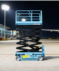 Industrial Scissor Lift Platform For Smooth Cargo Transfer And Equipment Maintenance Hydraulic Lifter in an airport at night with extended height.