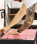 Person arranging pink fake skin from Beginner Friendly All In One Tattoo Practice Kit With Pink Fake Skin, Ink Cups, Machine Covers