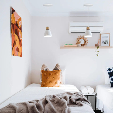Kiven Instant Light Conversion Kit for 4/5/6inch Hole lighting two pendant lights above cozy bedroom with pillows and decor.