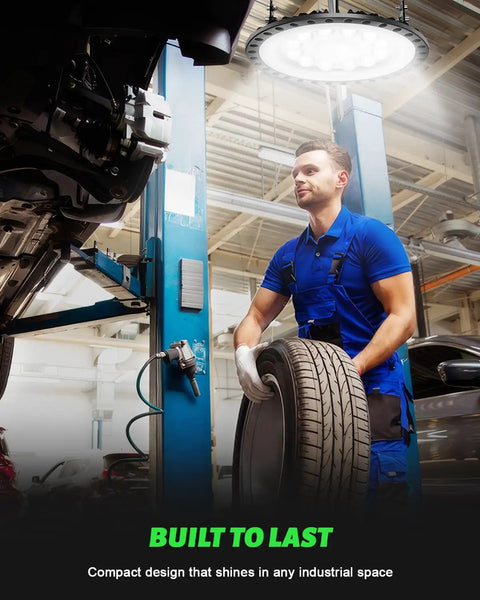 Mechanic holding tire illuminated by 20-Pack 200W UFO LED High Bay Lights, 20,000 Lumens, 5000K Daylight, 120V in garage