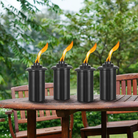 4 Pack Outdoor Metal Torch Set For Patio And Garden Decor Party Ready 59 Inch Tall Citronella Torch With Grounded 3 Prong Stake 16oz Fuel Capacity Table Top Or Yard Pathway Torches placed on a wooden table, showcasing metal construction and lit flames against a garden background.