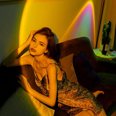Person lounging under a Sunset Lamp Projector For Room With Remote Control, 16 Color RGB LED Night Light for cozy living room decor