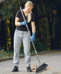 Woman using Adjustable 55 Inch Outdoor Broom For Pet Hair Removal And Heavy Duty Floor Cleaning Indoors And Outdoors in garden