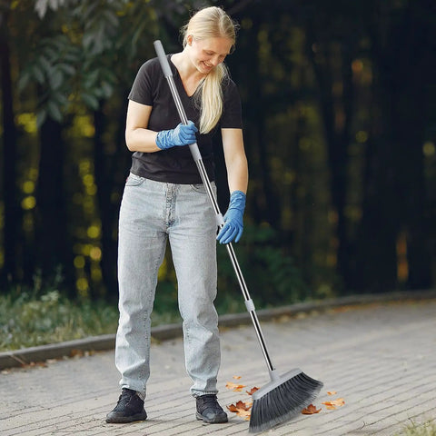 Woman using Adjustable 55 Inch Outdoor Broom For Pet Hair Removal And Heavy Duty Floor Cleaning Indoors And Outdoors in garden