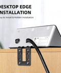 Totally Slick Two Pack Desk Edge Mount Power Strip With Four USB Ports And Three AC Outlets For Home Office Computer Setup Featuring Fast Smart Charging Tech And Reliable Surge Protection In Black, mounted underneath a desk with visible cable.