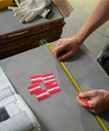 Measuring table next to Six Pack Self Adhesive Transparent Piano Hinges 45mm for DIY crafting and assembly projects.