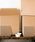 Corrugated Paper Pads 20x20cm with Protective Base Sturdy Cardboard Moving Box Filler Sheets displayed on wooden surface