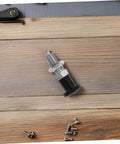 Built Damn Tough Stainless Steel Self Locking Indexing Plunger With Slick Spring Return Knob for precise jig alignment, laid on wood surface.