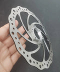 Close-up of 180mm Bicycle Disc Brake Rotor With Flange Adapter For Threaded Hubs Stainless Steel 2mm Thick Silver Finish