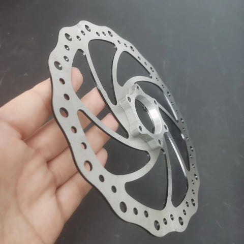 Close-up of 180mm Bicycle Disc Brake Rotor With Flange Adapter For Threaded Hubs Stainless Steel 2mm Thick Silver Finish