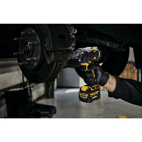 12V Max 3/8 Inch Cordless Impact Wrench Kit delivering hella tight torque in use for automotive repairs on a brake component.