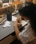 Get These Epic Glue Dispensing Bottles With Precision Nozzle Caps In Sleek Black, Perfect For Diy Crafts, Industrial Fixes, And Travel, black glue bottle on a desk with child crafting.