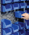 Person organizing blue plastic sorting bins in Badass Heavy Duty Deep Door Bin Cabinet for garage workspaces.