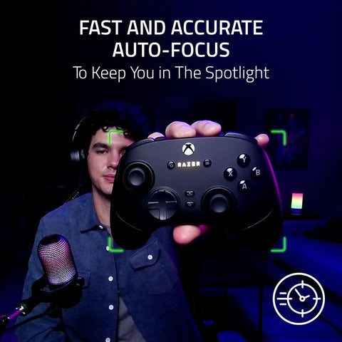 Premium 1440P 60 Fps Webcam With Lightning Fast Auto Focus For Seamless Streaming And Dope Video Calls Straight Up Game Changer USB plug and play camera focused on a user holding a Razer controller.