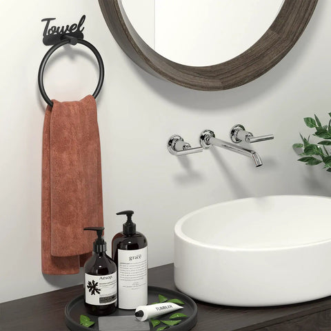 Bathroom setup with Rustproof Black Stainless Steel Towel Ring For Bathroom Wall Mounted Hand Towel Holder Easy Install Modern Minimalist Design holding a brown towel, near a sink and mirror.