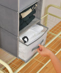 Big Time Hanging Closet Organizer With One Easy Fold Drawer And Three Roomy Shelves For No Sweat Closet Organization And Rock Solid Rod Mount Storage In Classic Grey with stacked clothes and slide drawer.