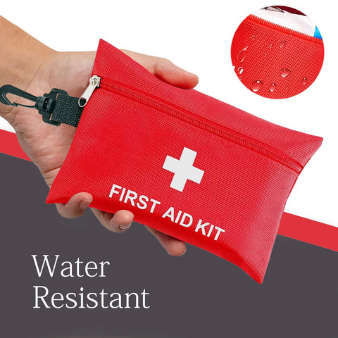 Red water-resistant travel first aid kit with white cross, zip pouch, and carabiner clip.