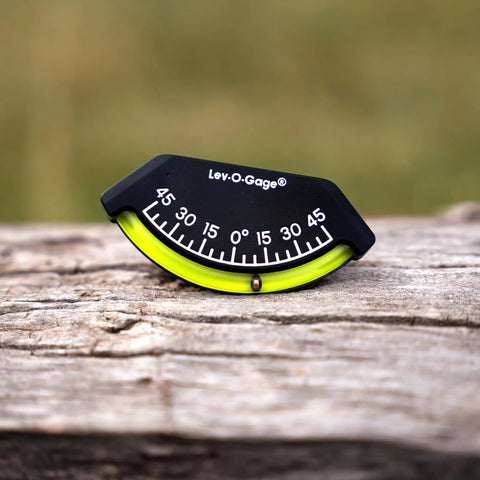 Close-up of 201-F Lev-O-Gage Inclinometer on wood surface, showing high visibility level gauge for off-road vehicles, USA made.