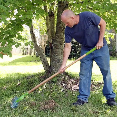 Person using 15 Inch Adjustable Self Cleaning Thatch Rake With Hardwood Handle For Lawn Care Curved Tines For Clearing Dead Grass Clippings