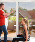 Couple installing Removable Static Cling Privacy And Decorative Glass Window Film For Home With UV Sun Protection No Glue No Residue