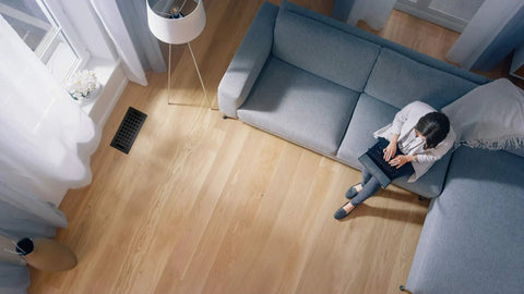 Living room with floor vent, featuring Slick Contemporary Artisan Style Vent Cover With Solid Cast Steel Interior And Adjustable Dampers For Easy Airflow Control Matte Black Four By Ten Inch Opening And Overall Face Five And A Quarter By Eleven And A Quarter Inches.