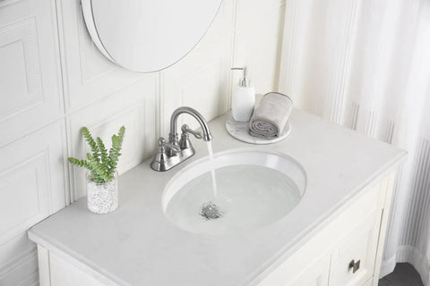 Two Handles Brushed Nickel Bathroom Faucet With Overflow Pop Up Drain for 3 Hole Sinks, 360 Degree Swivel Spout installed on white sink