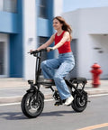 Woman riding powerful 1200W peak motor foldable ebike for adults with 25 MPH top speed and 45 mile PAS range in urban setting