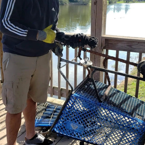 Man using Beast 180lb Ultra Strong Fishing Magnet Kit for river salvage with shopping cart