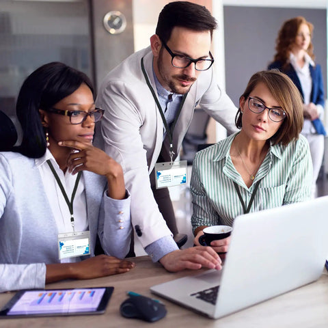 People at laptop wearing Clear Plastic Horizontal Name Tag Card Holders 30 Pack Paired With 30 Black Flat Neck Lanyards With Swivel Hook