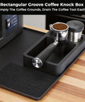 Silicone Coffee Mat For Ninja Luxe ES601 Espresso Machine Large Anti Slip Heat Resistant Bar Mat Built For Your Home Coffee Station Detachable 2 In 1 Design With Convex Edge Spill Proof Drying Rack Accessory next to a coffee knock box with accessories on a countertop.