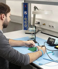 Person using ESD Soldering Mat Blue 600mm By 900mm Pro Grade Large Work Surface, showing anti-static and heat resistance features.